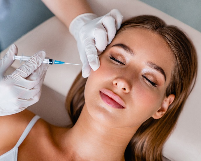 Woman receiving injection near her jaw