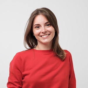 Woman smiling against neutral backdrop