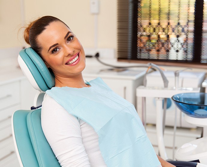 Smiling patient in dental treatment chair