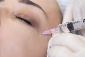 Woman receiving BOTOX injection near her eye